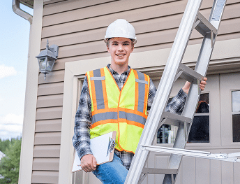 An exterior contractor on a ladder in a process of roof inspection