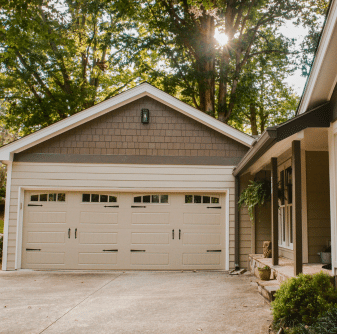 House with a two-car garage and mixed siding by siding contractor in atlanta
