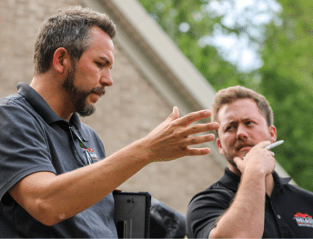 Nelson Exteriors sales reps discussing an exterior project with a fellow team member