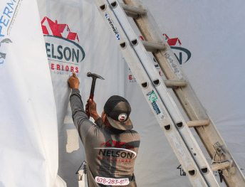 Nelson Exteriors installer working on exterior siding installation in Marietta, GA